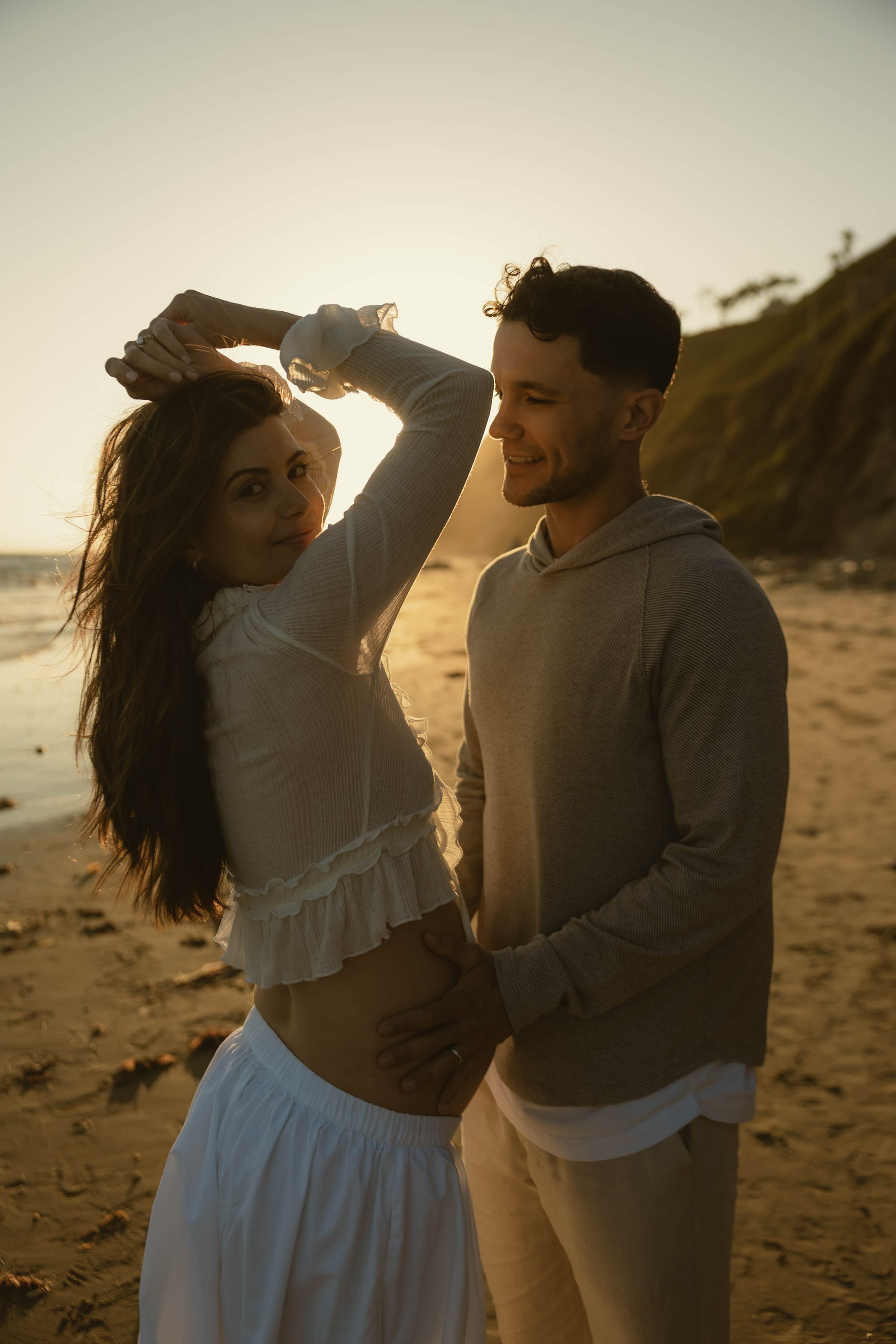 A couple embracing at sunset on the beach